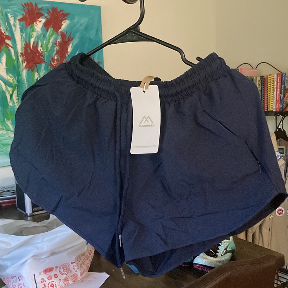 Running shorts with liner and 3 zipper pockets. New and still in bag.